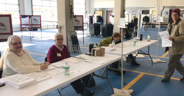 photo of volunteers and a voter at Voting Day